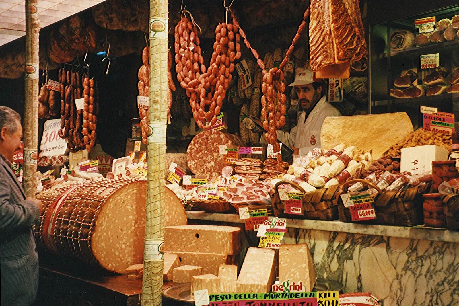Cured meats and cheeses at a deli counter in Florence